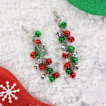 christmas bauble drop earrings with clip on attachment on snow covered white background
