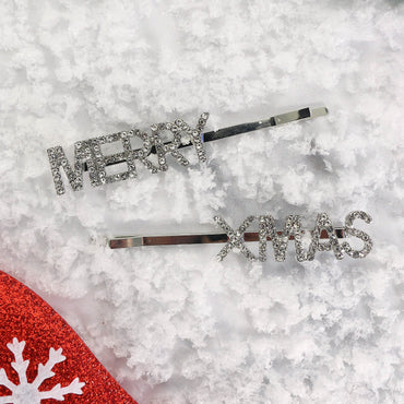 merry xmas hair slides on white background with snow styled beside red glitter novetly accessories