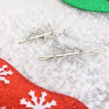 christmas tree outline hair slides with diamante embellishment on white snow covered background