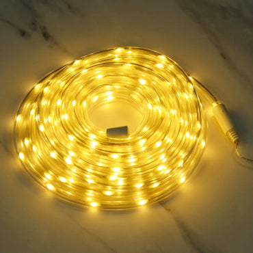 Coil of warm white LED rope light lit up on a marble floor