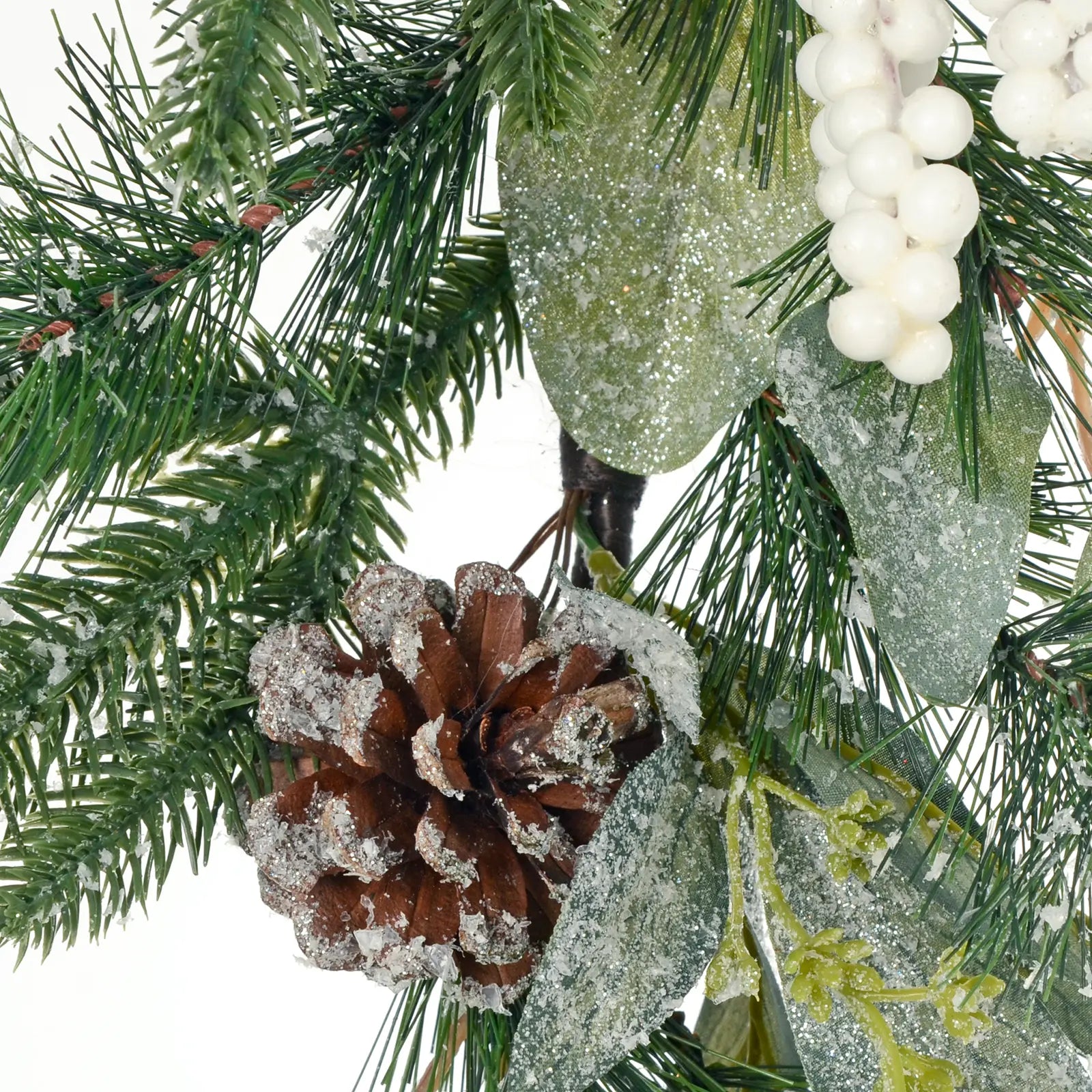 detail shot of frosted glitter leaves and artifical pine cone