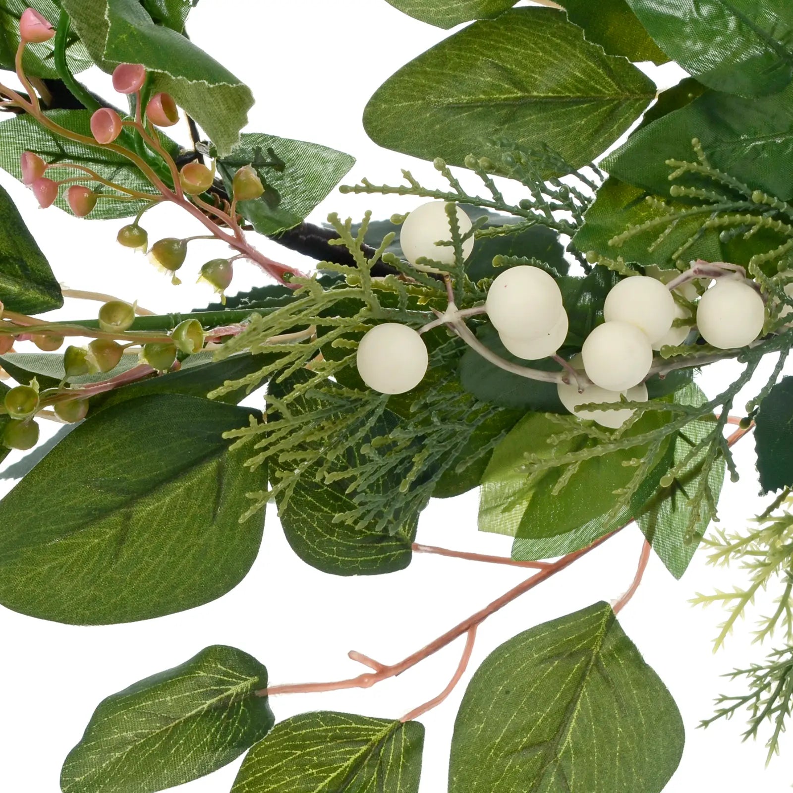 detail shot of white berry clusters, pe needles and PVC flower sprays nestled between silk foliage