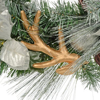 detail shot of gold reindeer antler decorated nestled amongst silver and green tips with silver glitter bauble