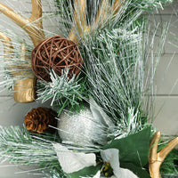 brown colour rattan bauble on mixed pine christmas wreath with silver snowy tips