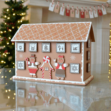 gingerbread advent calendar on coffee table in front of christmas tree and card holder with christmas cards