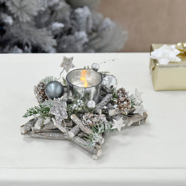 Mr Crimbo star shape Christmas candle holder with grey twig base, silver baubles, stars and frosted foliage on a table with Christmas present