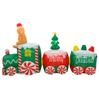 Gingerbread figure on a candy train large Christmas inflatable decoration in green, red and white with Christmas tree and Merry Christmas written on the side 