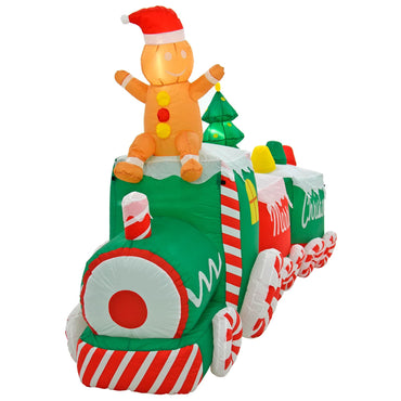 Front view of a Christmas candy train inflatable decoration with gingerbread figure sitting on the engine