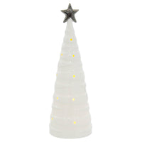 White ceramic Christmas tree shape ornament with warm white LED light shining through cut away baubles and topped with a silver star