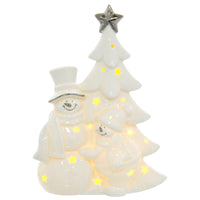 Light up Snowmen with Christmas tree ornament in white ceramic with silver detail lit by a warm white LED light sining through cut away stars