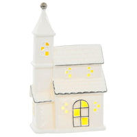Light up white ceramic town house Christmas ornament with silver detailing and a warm white LED light shining through the windows and door