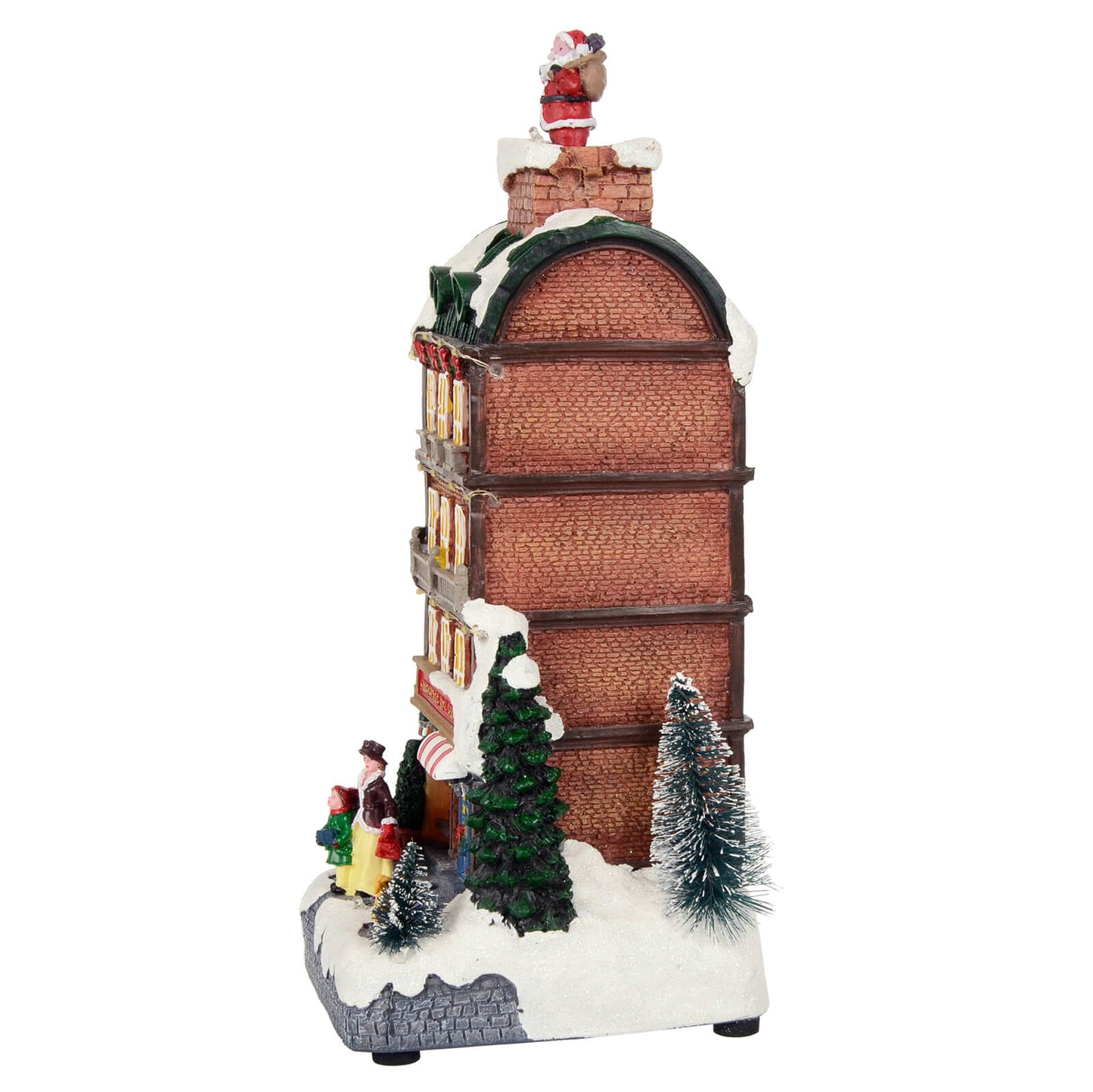Side view of Christmas toy shop snow scene with Santa coming out of the chimney, red brick walls and glittering snow