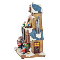 Side view of toy factory Christmas snow scene ornament with Santa and elves