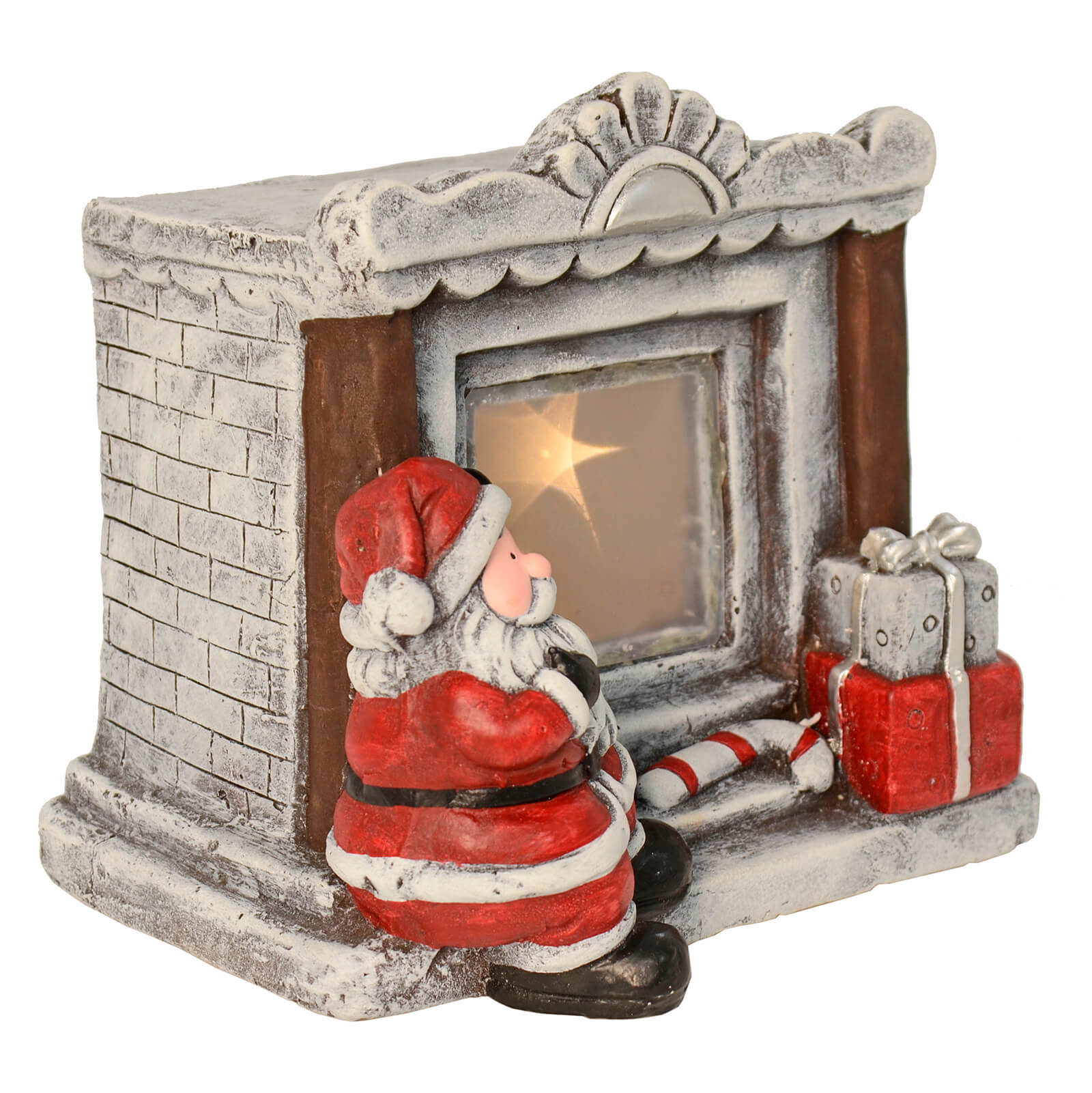 Side view of Santa Claus stitting at a fireplace Christmas ornament with light up stars, retro mantelpiece, stock, candy cane and Christmas presents