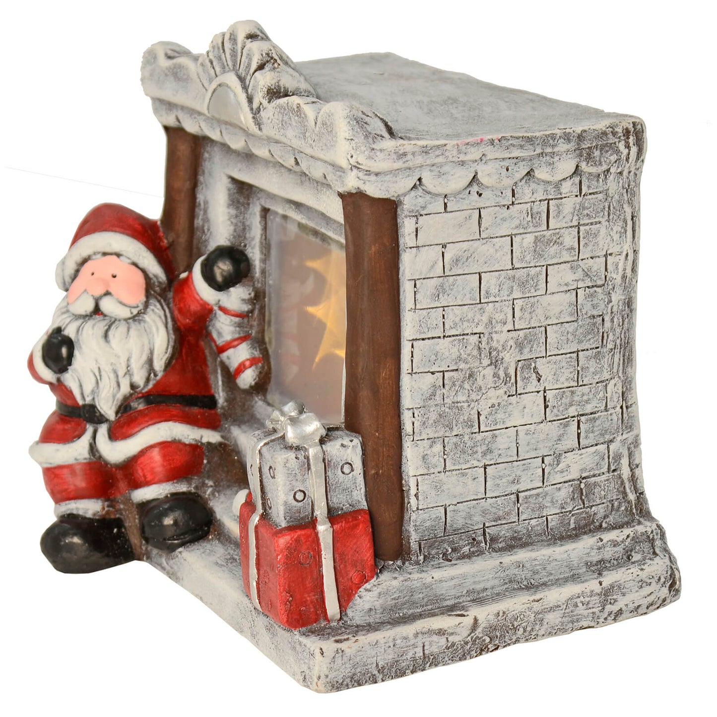 Side view of Christmas ornament with Santa sitting at a large grey brick fireplace with light up stars, Christmas presents, stocking and candy cane