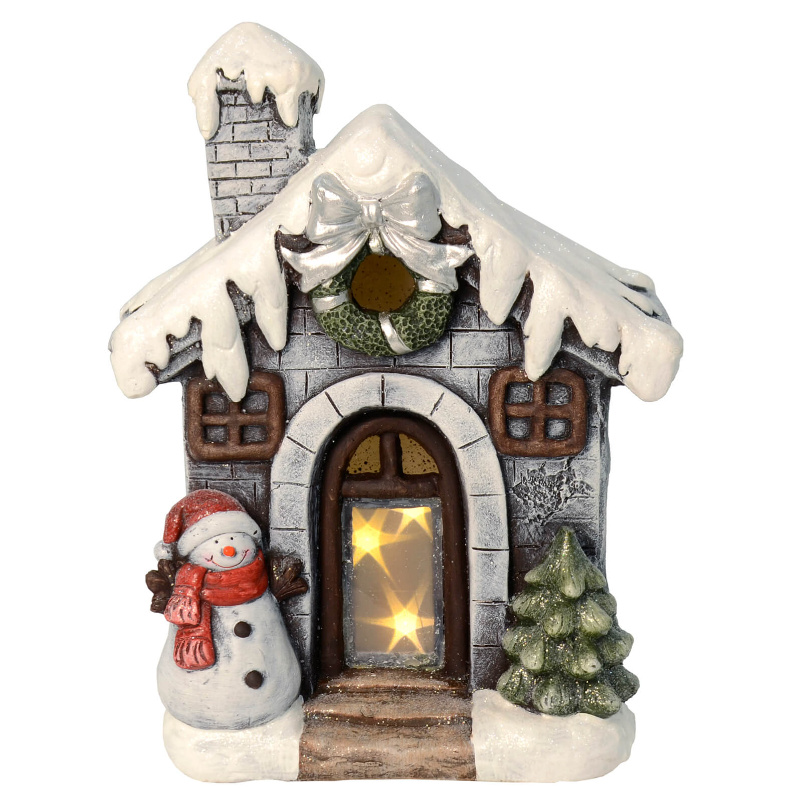 Christmas ornament with snowman and tree outside a snow covered house with wreath, silver ribbon and light up LED stars in the doorway