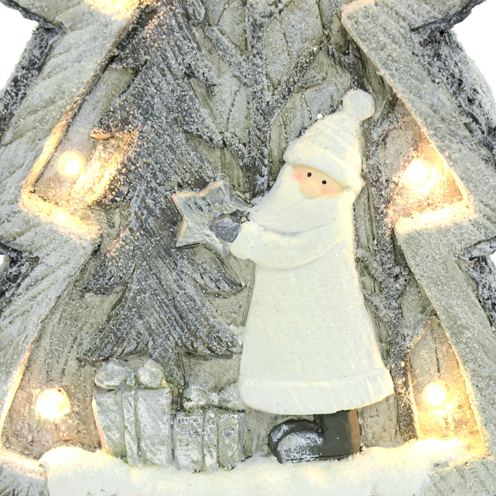 Close up of white and grey Santa with star snow scene with warm white LED light and carved wood effect finish.s