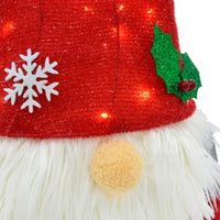 Close up detail of light up Christmas Gonk figure with warm white LED lights, red glitter hat with snowflakes and holly berries