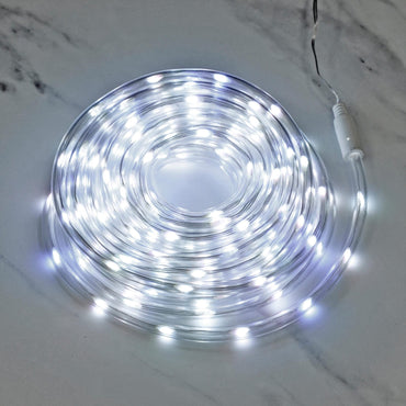 cool white rope light fro Christmas decoration lit up in a coil on a marble floor