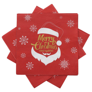 red napkin features merry christmas everyone slogan in gold with santa claus face outline